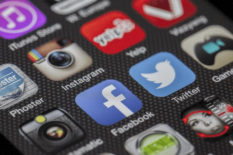 Social media app icons on smartphone screen, including Facebook, Twitter, Instagram, YouTube, and privacy settings, close-up