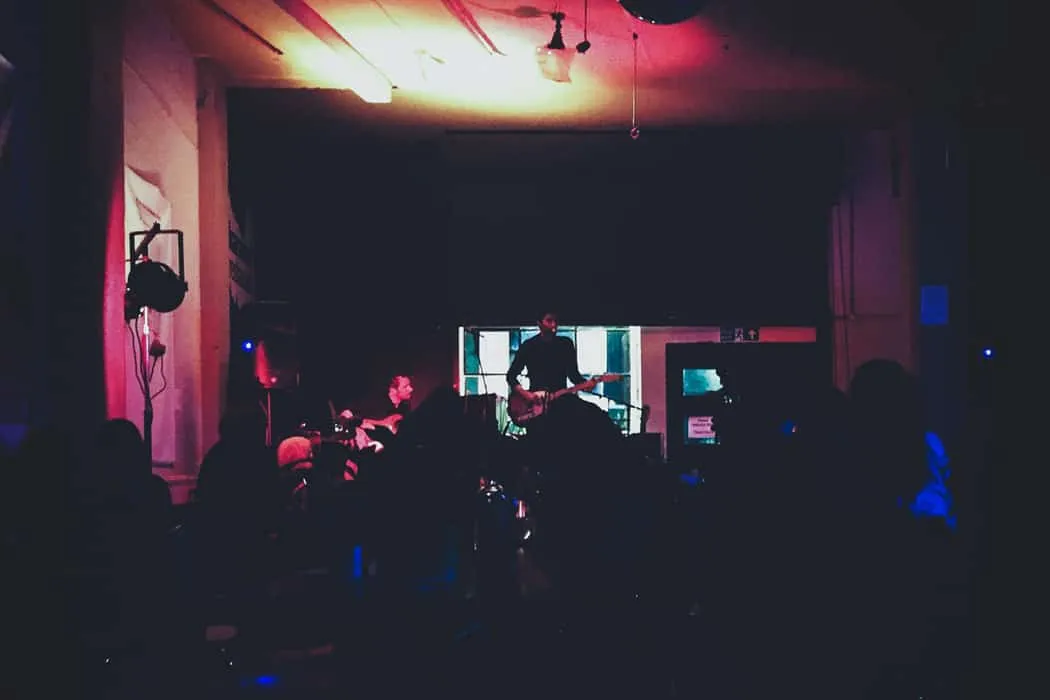 Creative live music performance with guitarists and audience, showcasing an intimate indoor concert setting, perfect for prom