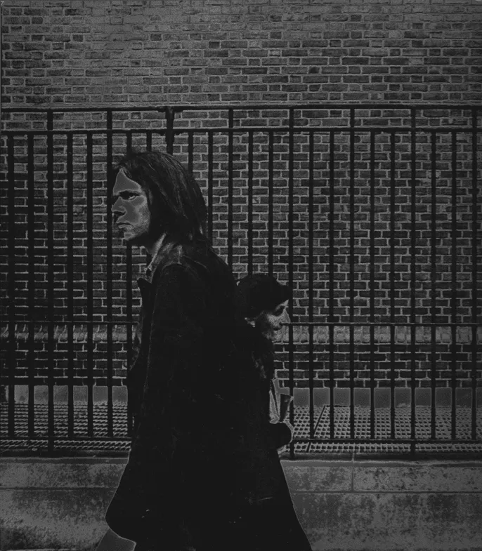 Urban street scene with two women walking past a brick wall, black and white photography, moody atmosphere, modern city lifes