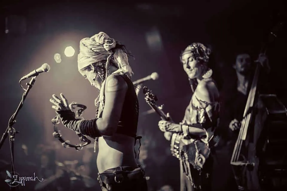 Unique musical performance featuring jazz musicians with a tambourine and double bass on stage at Hypebot.