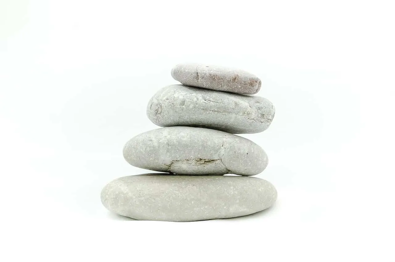 Stacked gray and white smooth stones representing balance and zen relaxation.