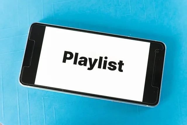 Playlist on smartphone screen for digital music and streaming, music management, online playlists, music apps, digital entert