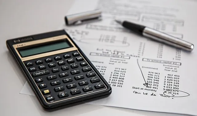 Calculator on financial documents for accounting and budgeting analysis.