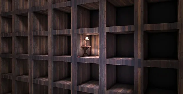 Empty wooden shelving unit with a single lit lamp in one compartment, creating a warm and cozy ambiance.