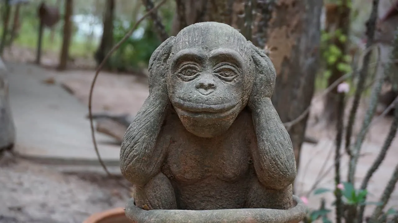 Ancient stone monkey sculpture strategically positioned in a lush forest setting, symbolizing nature-inspired art and cultura