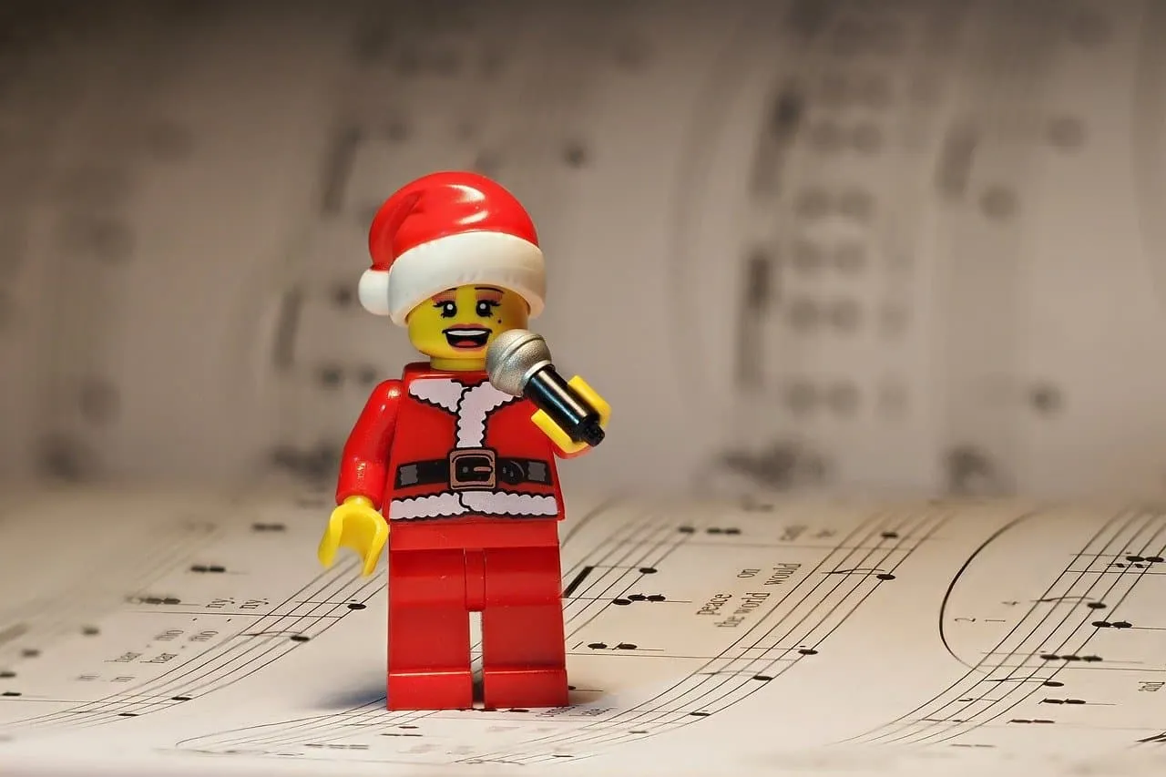 Lego Santa Claus figurine singing with a microphone, Christmas music notes background, holiday music, festive season, toy fig