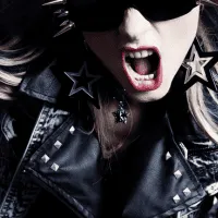 Dark-clad woman wearing sunglasses and star-shaped earrings, expressing excitement or intensity, representing music, youth cu