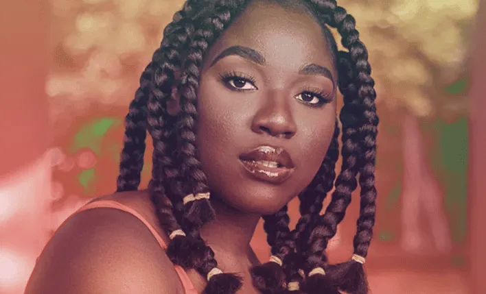 Black woman with braided hairstyle outdoors, showcasing beauty and confidence for lifestyle and fashion photography.