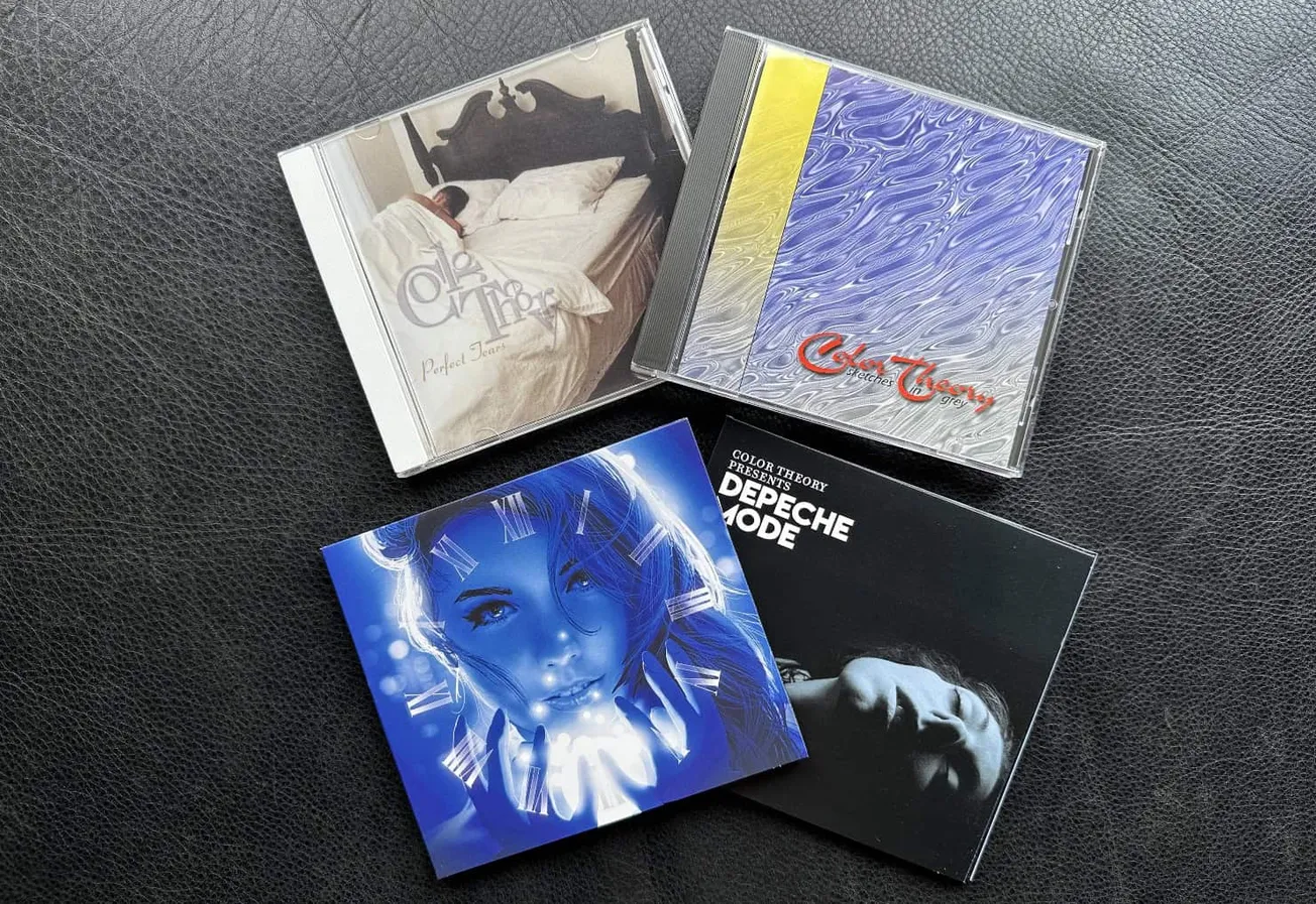CD albums showcasing music from Depeche Mode and other artists, featuring artistic cover designs and vibrant artwork, placed