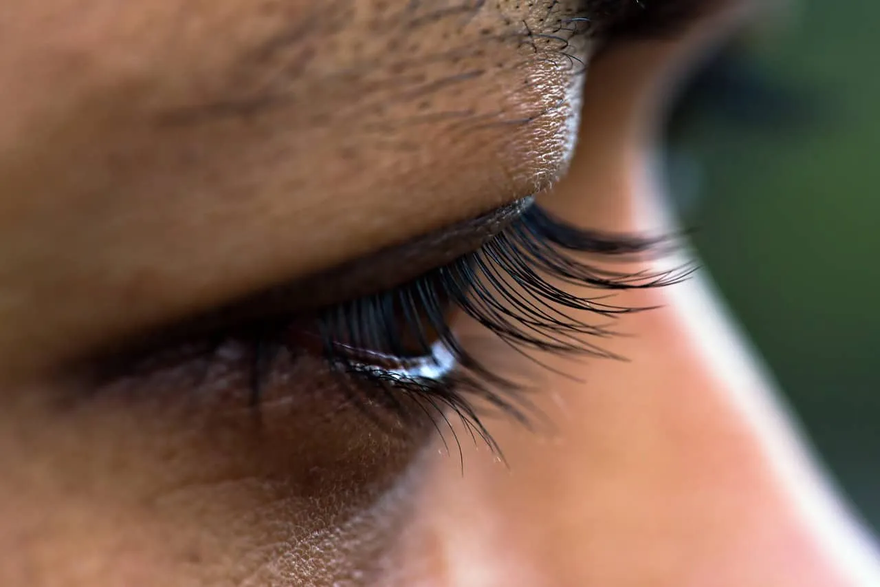 Close-up of a person's eye with detailed eyelashes and skin texture, highlighting beauty and skincare focus for social media