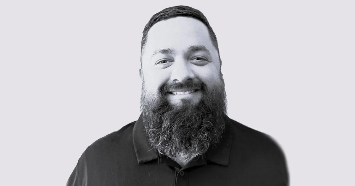 Bearded man smiling in a black polo shirt, representing music industry insights, media, and digital marketing on Hypebot plat