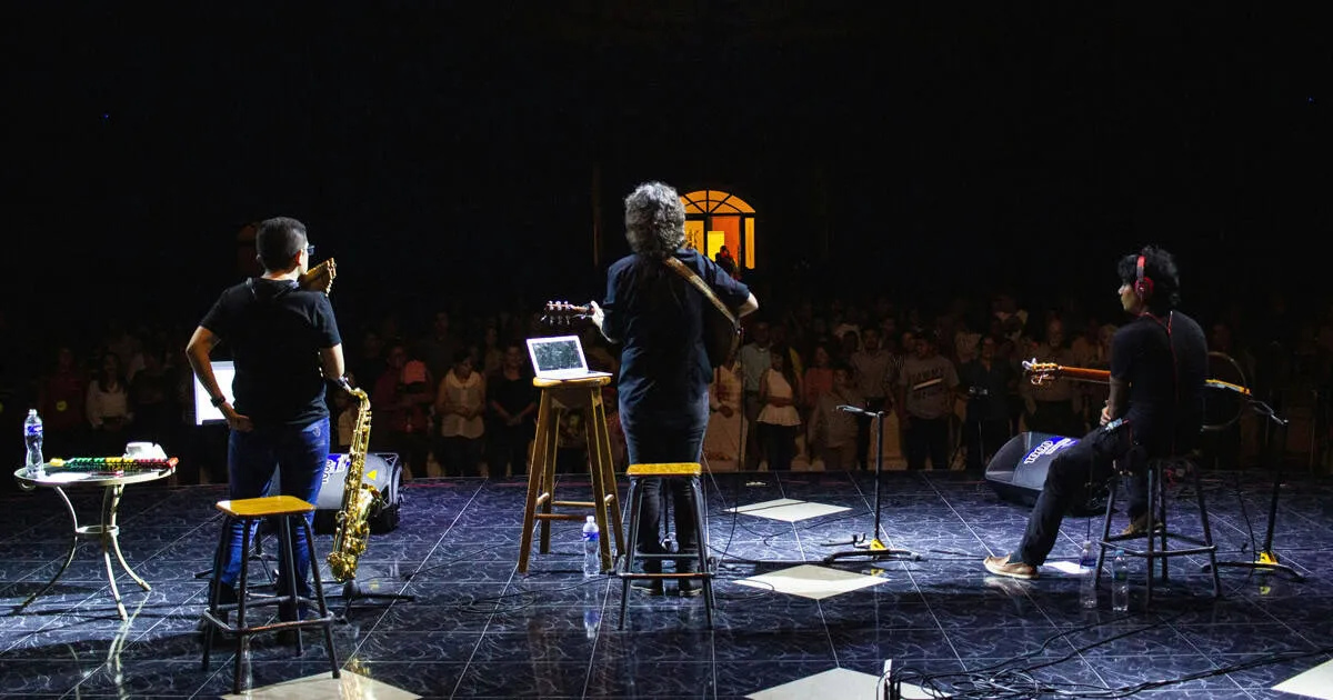 band on stage giving a presentation.