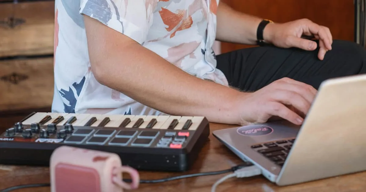 man producing music in at-home studio environment