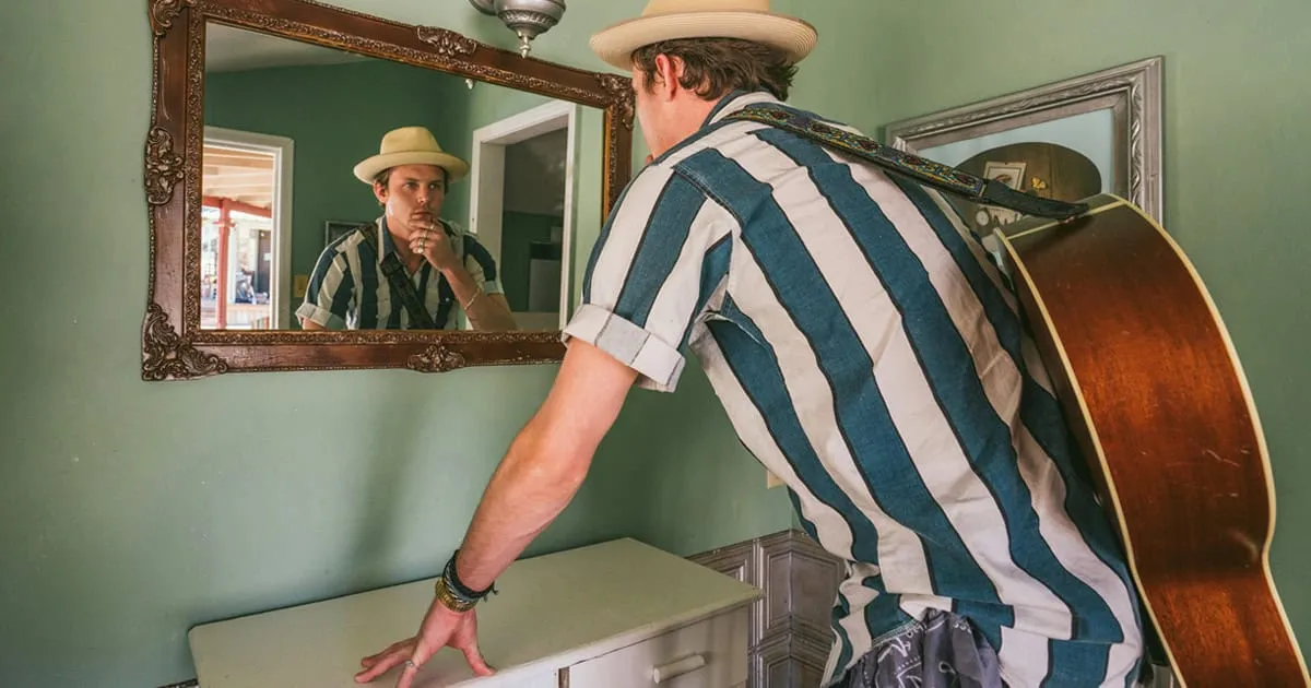 Male Musician looking in the mirror