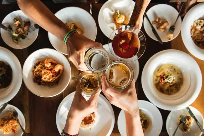 Cheers-ing-with-beer-and-wine-at-dinner-party-celebration-reward.