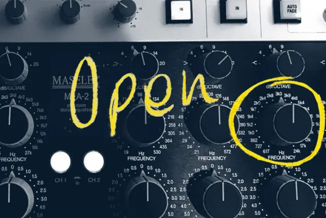 Frequency control knobs on audio mixing console for music production.