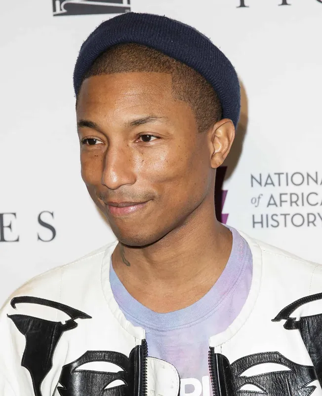 Vibrant portrait of a young man wearing a blue beanie, confident expression at a cultural event, showcasing diversity and mod
