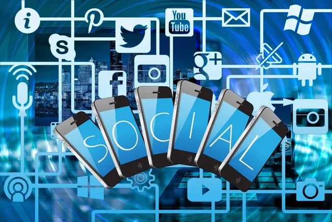 Smartphones displaying the word "Social" over a digital cityscape and social media icons, representing social media marketing