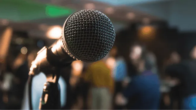 Microphone on stage at a music industry event, ready for a live performance or speaking engagement for artists and music prof