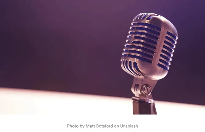 Vintage silver microphone on adjustable stand, suitable for podcasts, live performances, and broadcasting. Perfect for music,