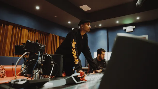 Music producers working in a professional recording studio, focusing on mixing and sound engineering for upcoming music proje