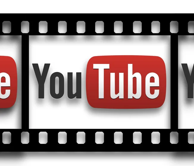 YouTube logo on filmstrip background, emphasizing online video, digital media, and content creation.