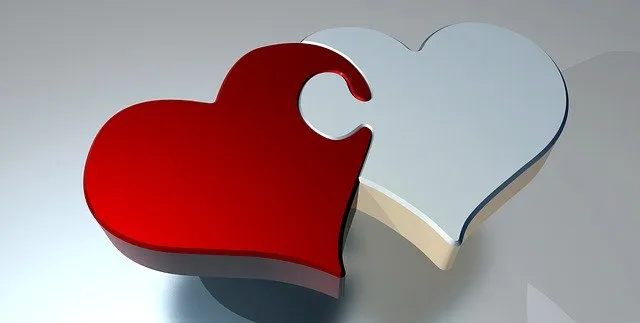 Puzzle piece heart with red and white colors symbolizing love and connection, representing themes of relationships, emotional