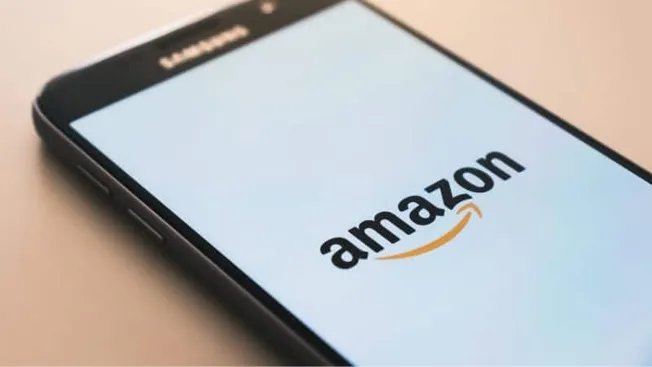 Amazon shopping app on smartphone screen, online retail, mobile commerce, e-commerce platform, digital shopping, Amazon logo,
