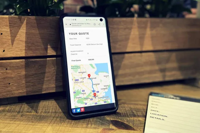 Smartphone displaying a travel quote calculator app with a route map on the screen.