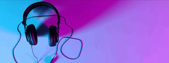 Headphones on a vibrant, colorful background with gradient shades of blue, purple, and pink, perfect for music, audio, and en