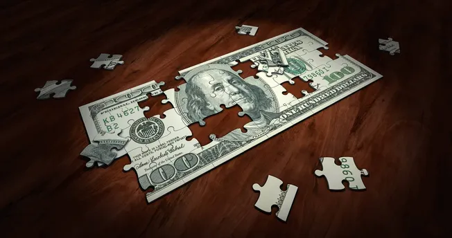 Jagged puzzle pieces assembling a 100-dollar bill, symbolizing financial complexity and investment challenges.