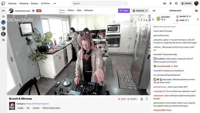 DJ woman mixing music at a kitchen-themed live stream event, showcasing the intersection of music performance and casual home