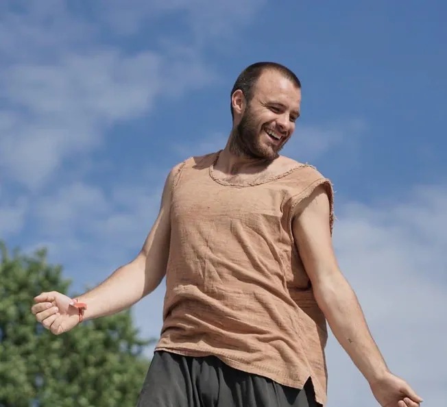 Happy man outdoors enjoying sunshine, vegan lifestyle, environmental sustainability, and outdoor activities; promoting wellne