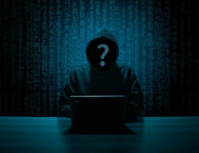 Cryptic hacker with question mark on face in dark digital matrix background.