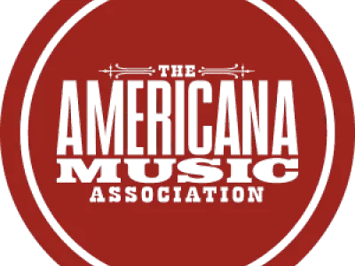 A vibrant red circular logo for the Americana Music Association featuring bold text.