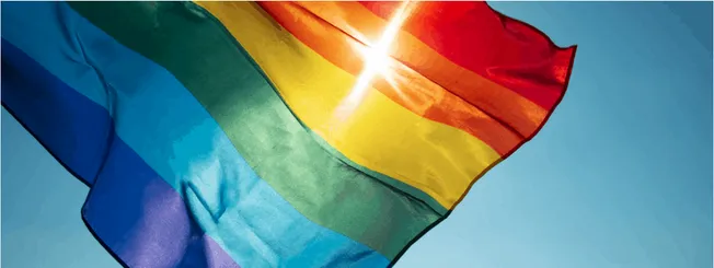 Vibrant rainbow pride flag waving in the sky symbolizing LGBTQ+ pride, equality, and diversity. Ideal for content on LGBTQ+ r