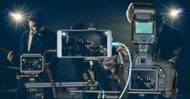 Recording professional music performances with DSLR camera and lighting equipment at a live concert.