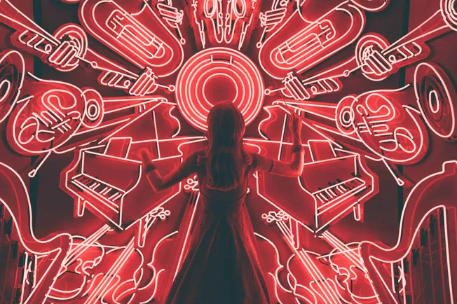 Bright neon musical instruments and notes wall art at Hypebot, showcasing vibrant concert and music industry visuals in red g