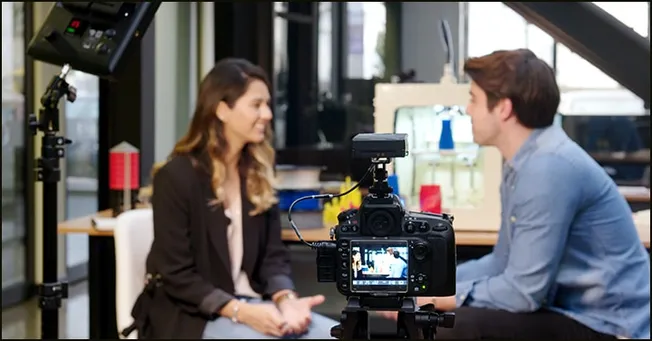 Interview recording setup with professional camera and lighting for media interview or content creation.