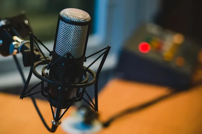 Microphone in a professional recording studio or podcast setup, ready for high-quality audio recording.