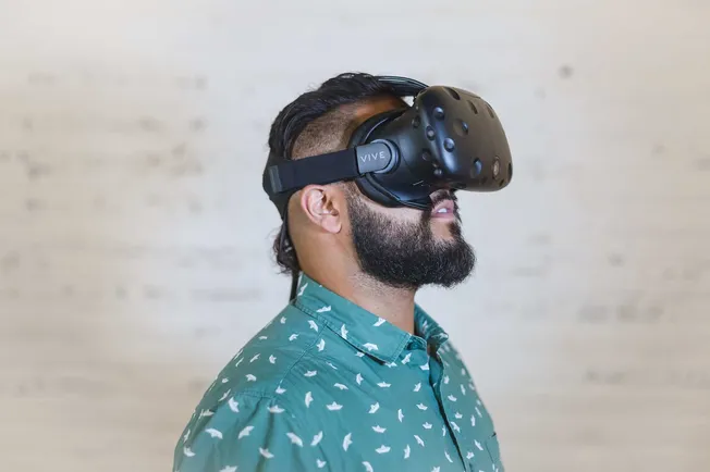 VR headset user experiencing immersive virtual reality, wearing HTC Vive virtual reality goggles for gaming or digital experi