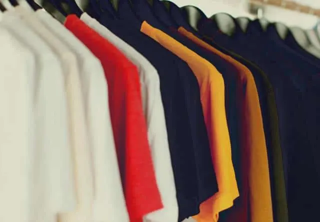 Clothing rack with colorful t-shirts and hoodies, casual fashion, retail store display, vibrant apparel, fashion industry, tr