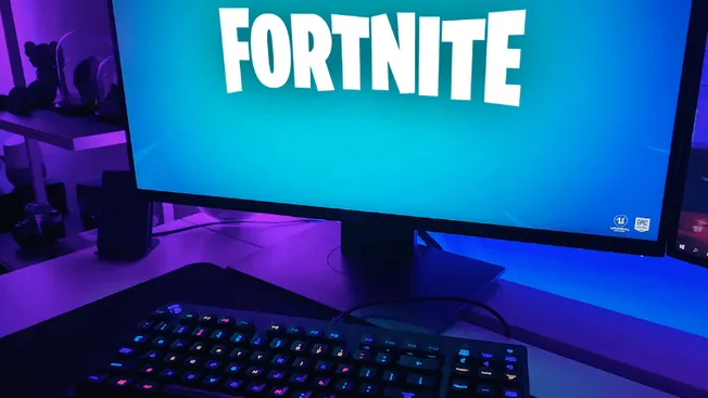 Fortnite on gaming monitor with RGB keyboard in a modern gaming setup for gaming, esports, and live streaming enthusiasts.