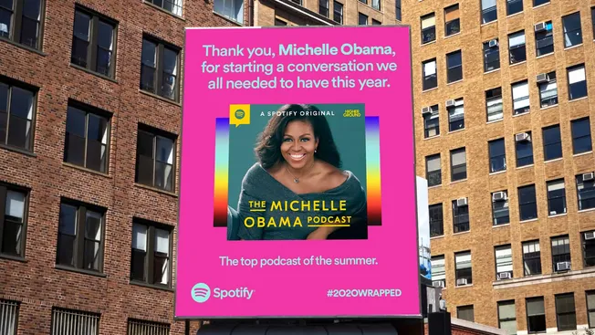 Michelle Obama on podcast billboard in urban setting, celebrating seasons of conversations, featuring Spotify and hashtag #20