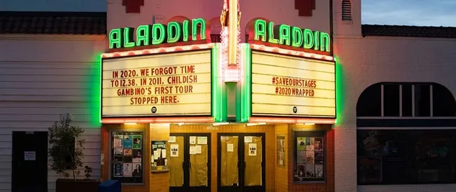 Aladdin Theatre marquee with neon lights and historical movie posters, showcasing music and entertainment venue in Hollywood,