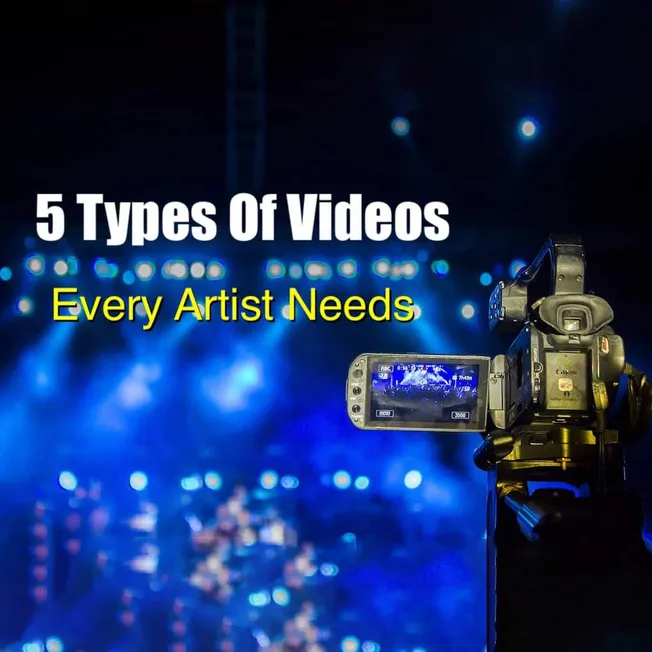 Professional camera capturing live concert performance with vibrant blue stage lights, emphasizing video production and artis