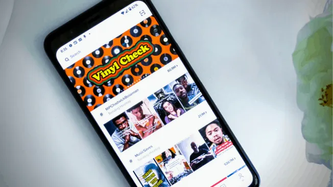 Viney Check YouTube channel homepage on a smartphone screen showcasing music and entertainment videos related to digital musi