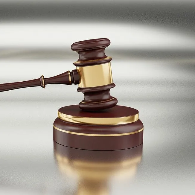 Gavel resting on sound block, symbolizing legal authority and justice, often associated with court rulings, legal decisions,