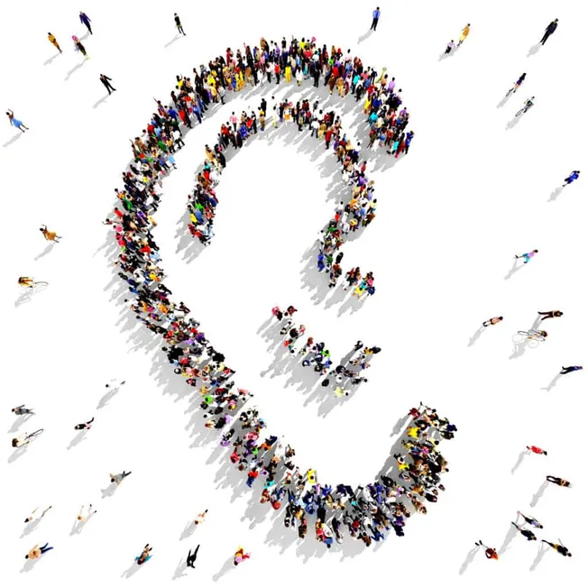 Crowd of people forming a question mark symbol, representing curiosity and inquiry in music industry questions and trends, di