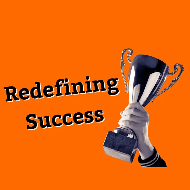 Trophy being held by a person's hand with the text "Redefining Success" on a solid orange background, symbolizing achievement